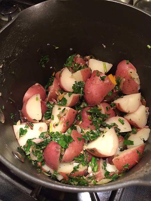 Potatoes with Swiss Chard Pesto in a metal bowl