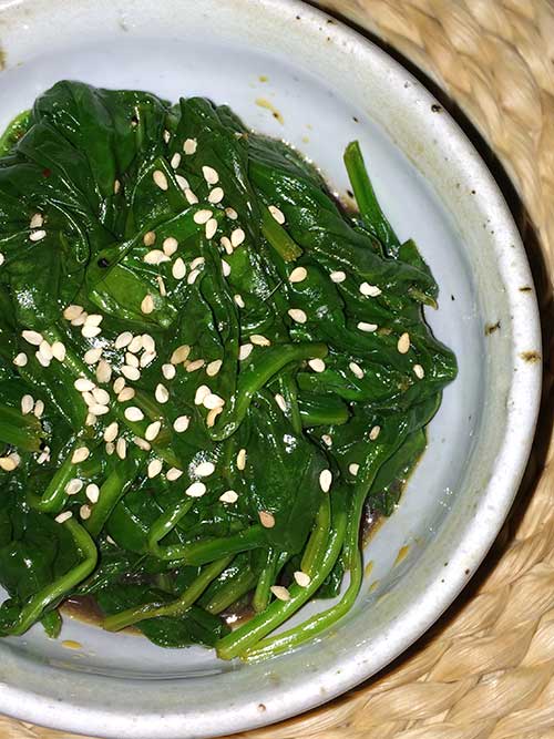 close-up of Szechuan Spinach in a white bowl