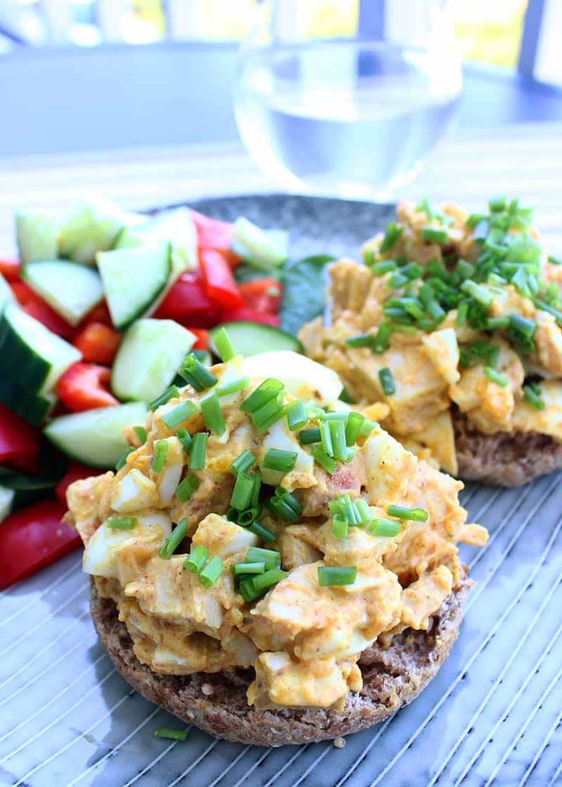 Chicken and Egg Salad on a muffin with chives on top