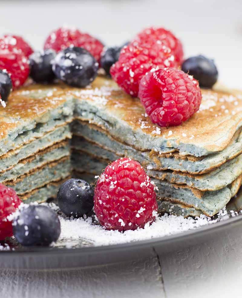 Closeup of a stack of pancakes with a quarter cut out