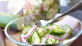 Pickled cucumber salad in glass bowl