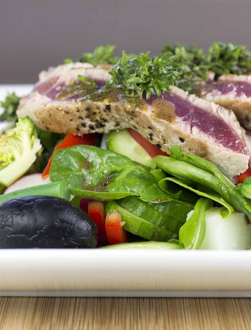 Tuna nicoise salad on a white plate