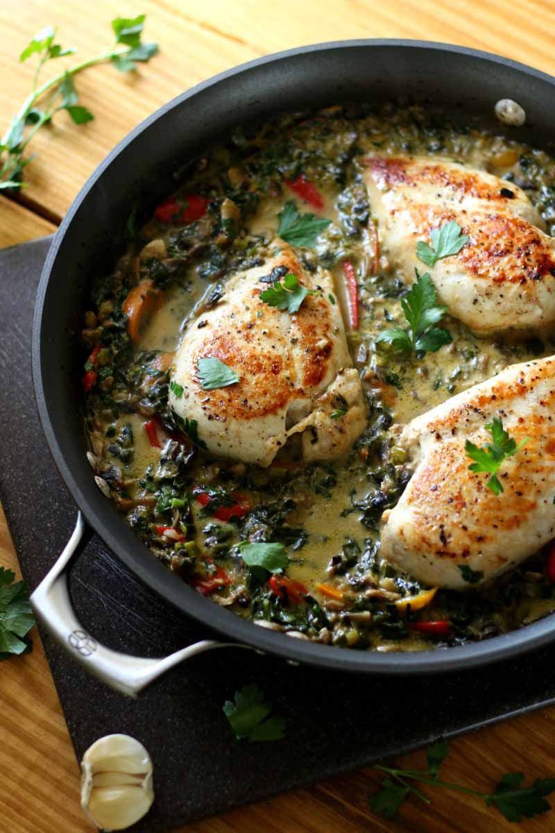 Cooked Smothered Creamy Chicken Skillet in a cast iron pan 