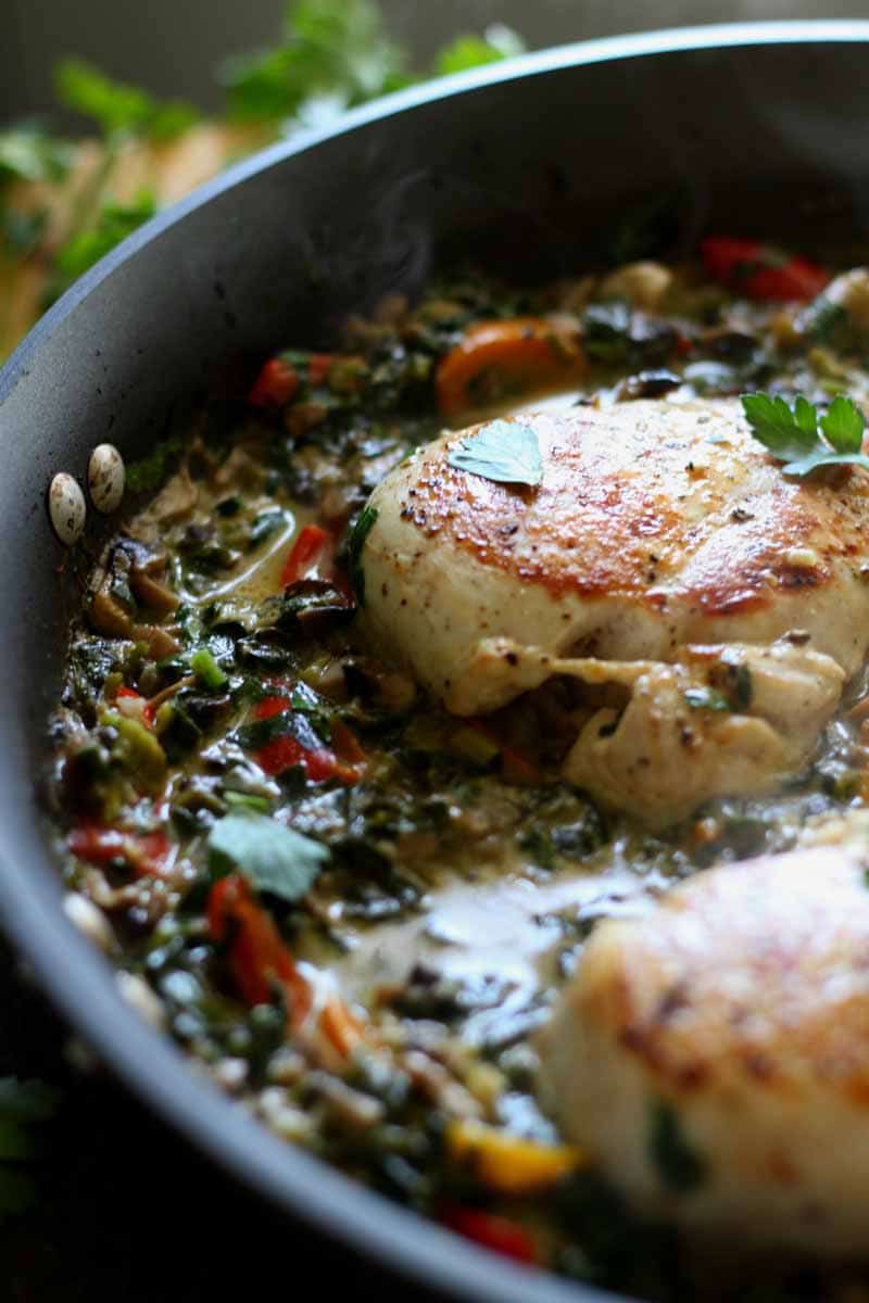 Closeup of chicken breast and sauce in the skillet