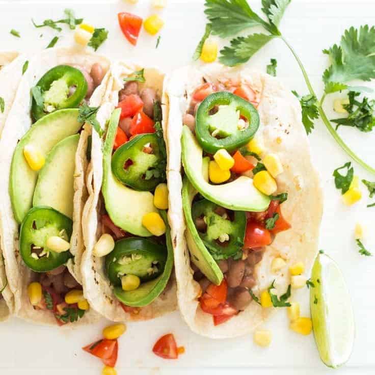 Three tacos assembled and ready to be eaten, as seen from above