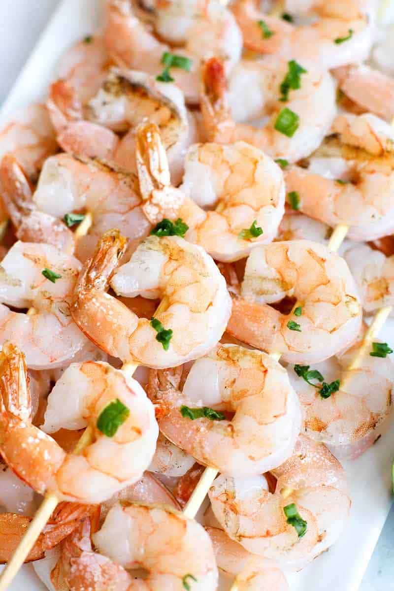 Grilled Shrimp Skewers stacked on a platter