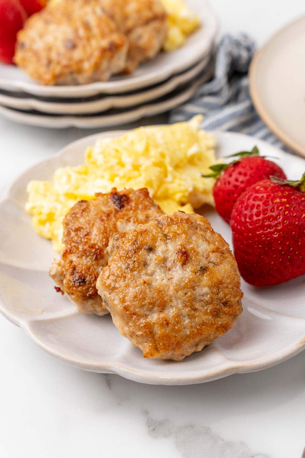 Plate with sausages, scrambled eggs, and strawberries