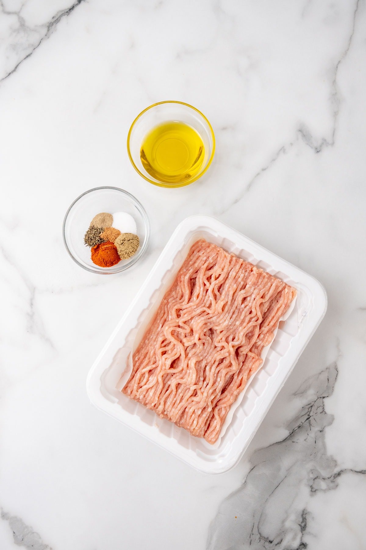 Ingredients for the sausages on a marble surface