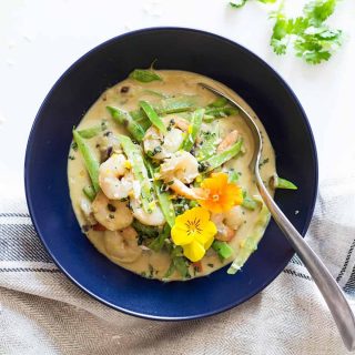 Thai Green Curry in a blue bowl with a spoon