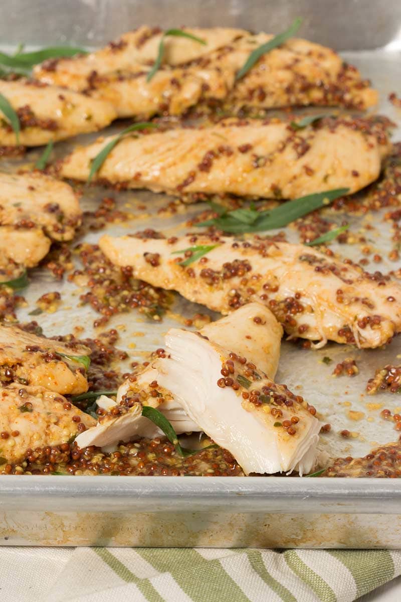 Mustard Baked Chicken Tenders in a baking dish, ready to be served