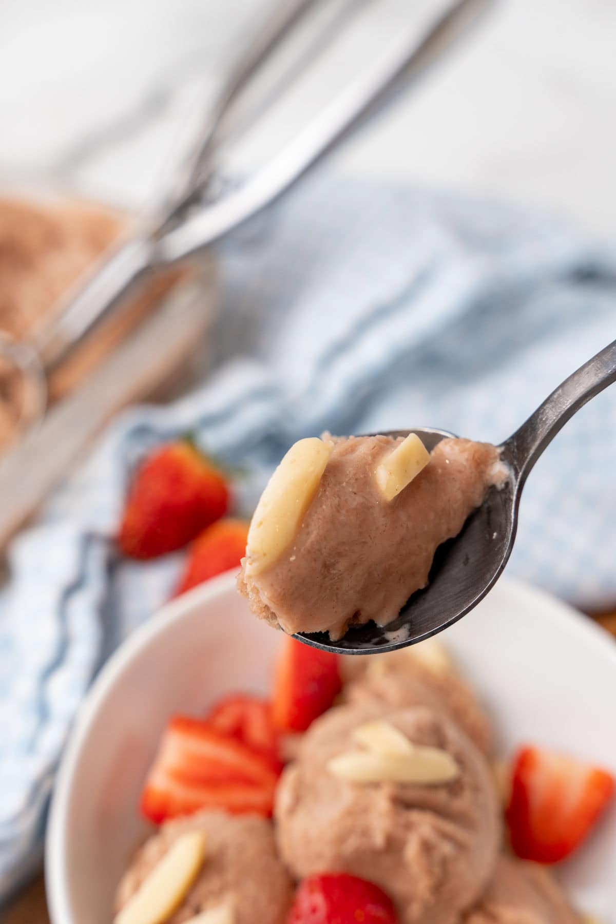 Spoon scooping ice cream from a bowl