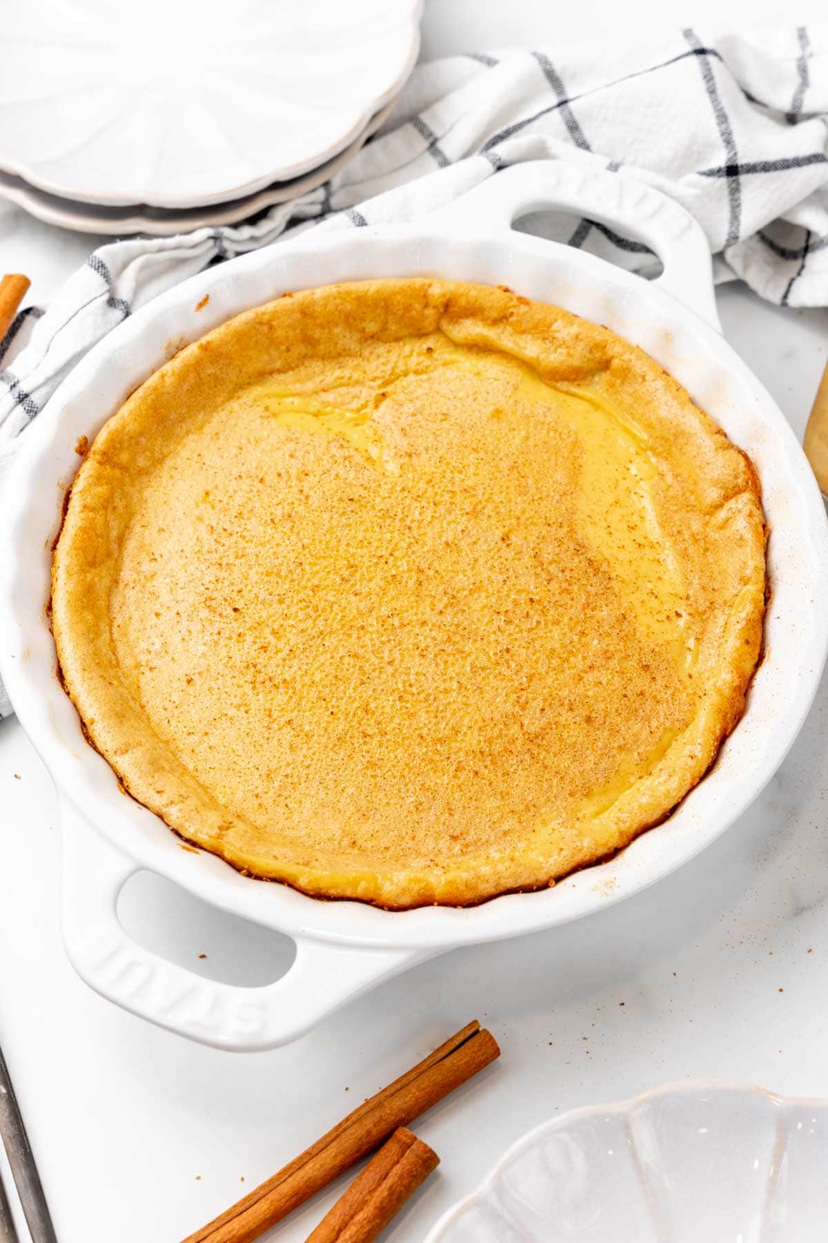 Finished crustless custard pie cooling on a table