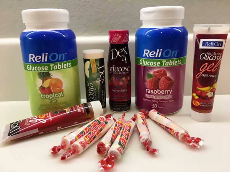 A collection of glucose tabs, glucose gels, and sugar candies on a table