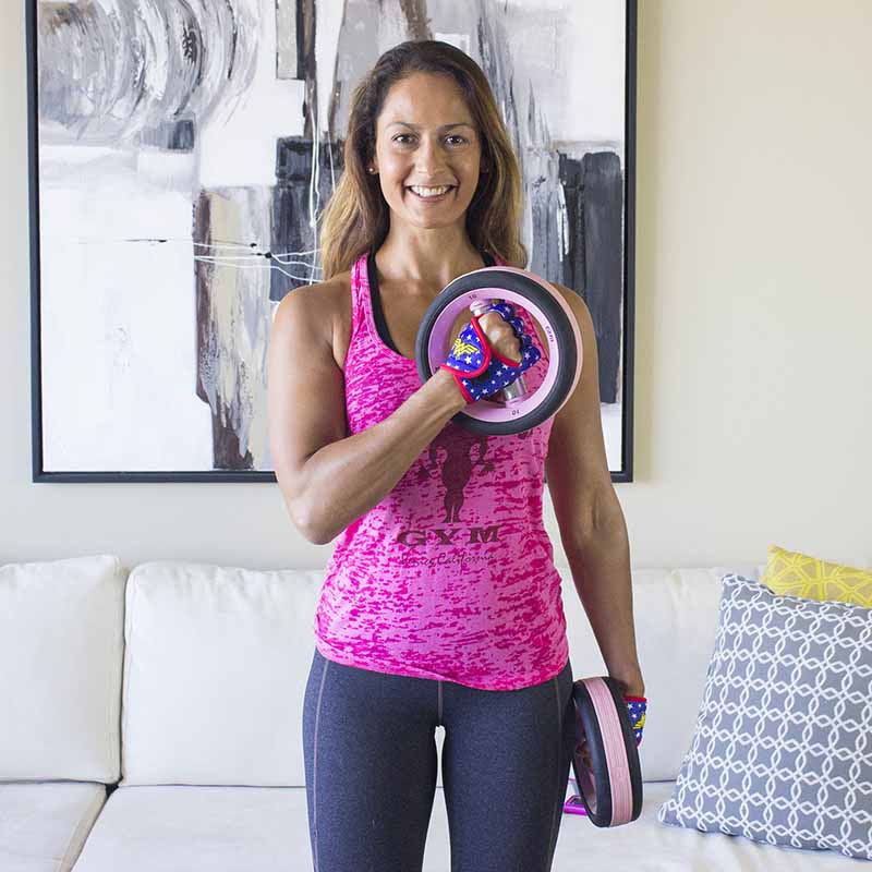 Christel doing biceps curls in her living room