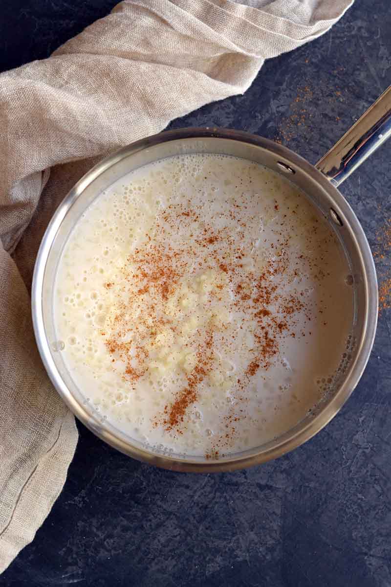 Cauliflower rice, almond milk, and cinnamon in a pot