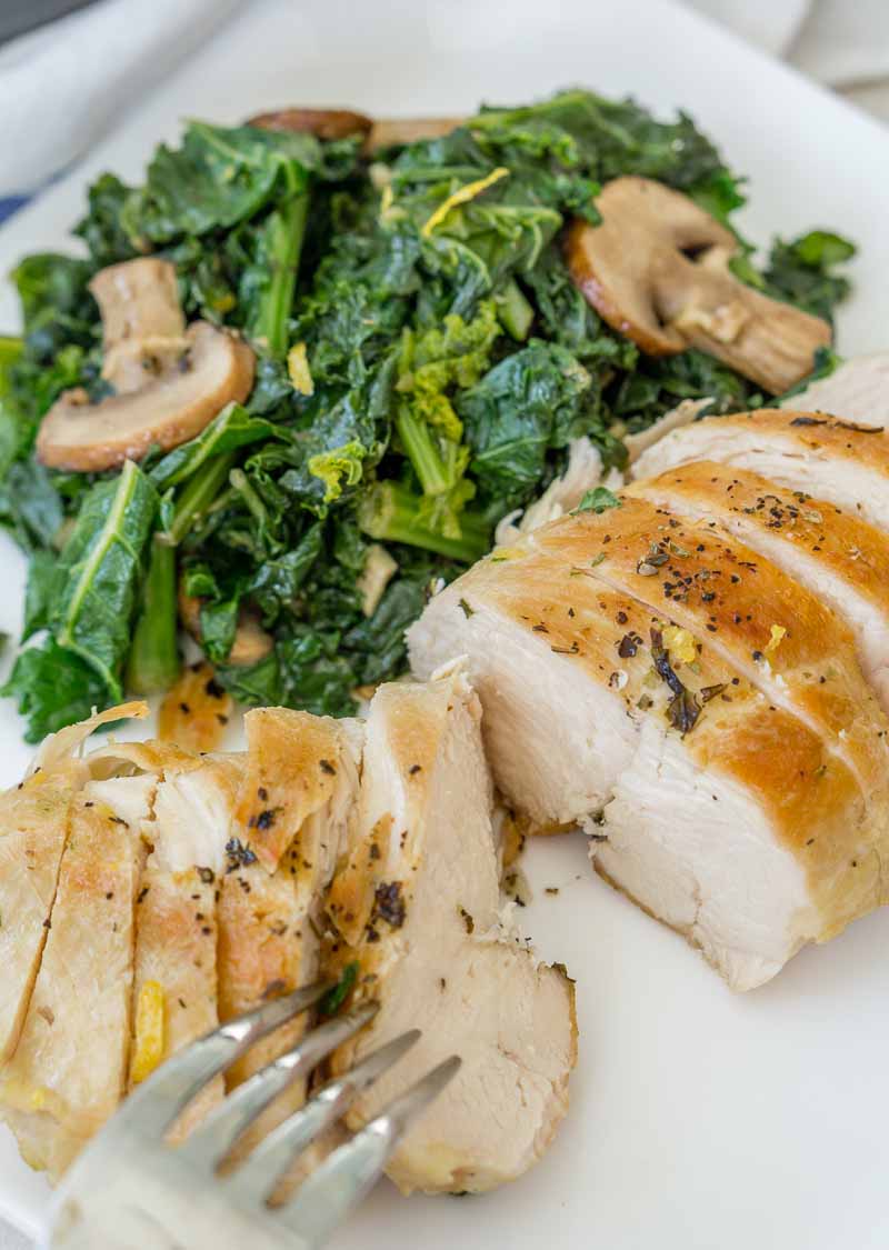 Healthy chicken and mushroom skillet with kale, plated and sliced