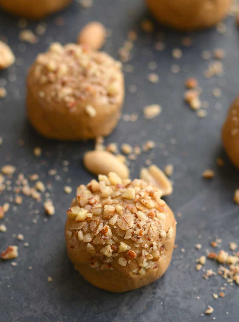 2 peanut butter protein balls on a black surface