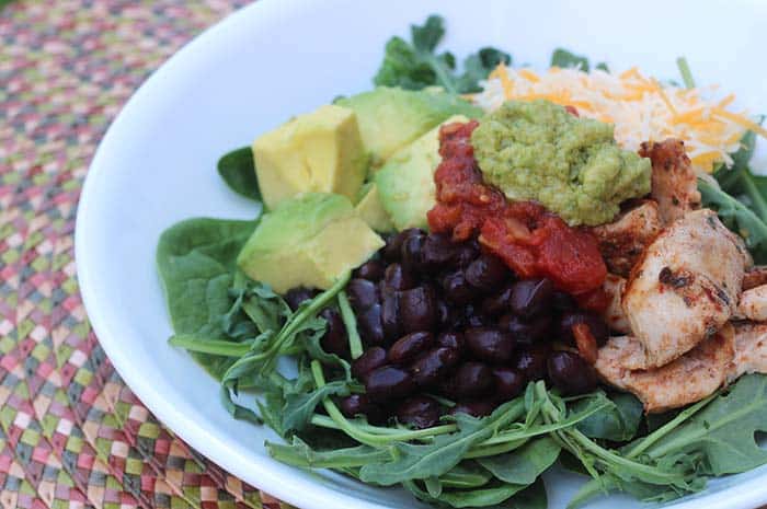 Close- up of Tex-Mex Burrito Bowl with Lime-Avocado Sauce in a white bowl