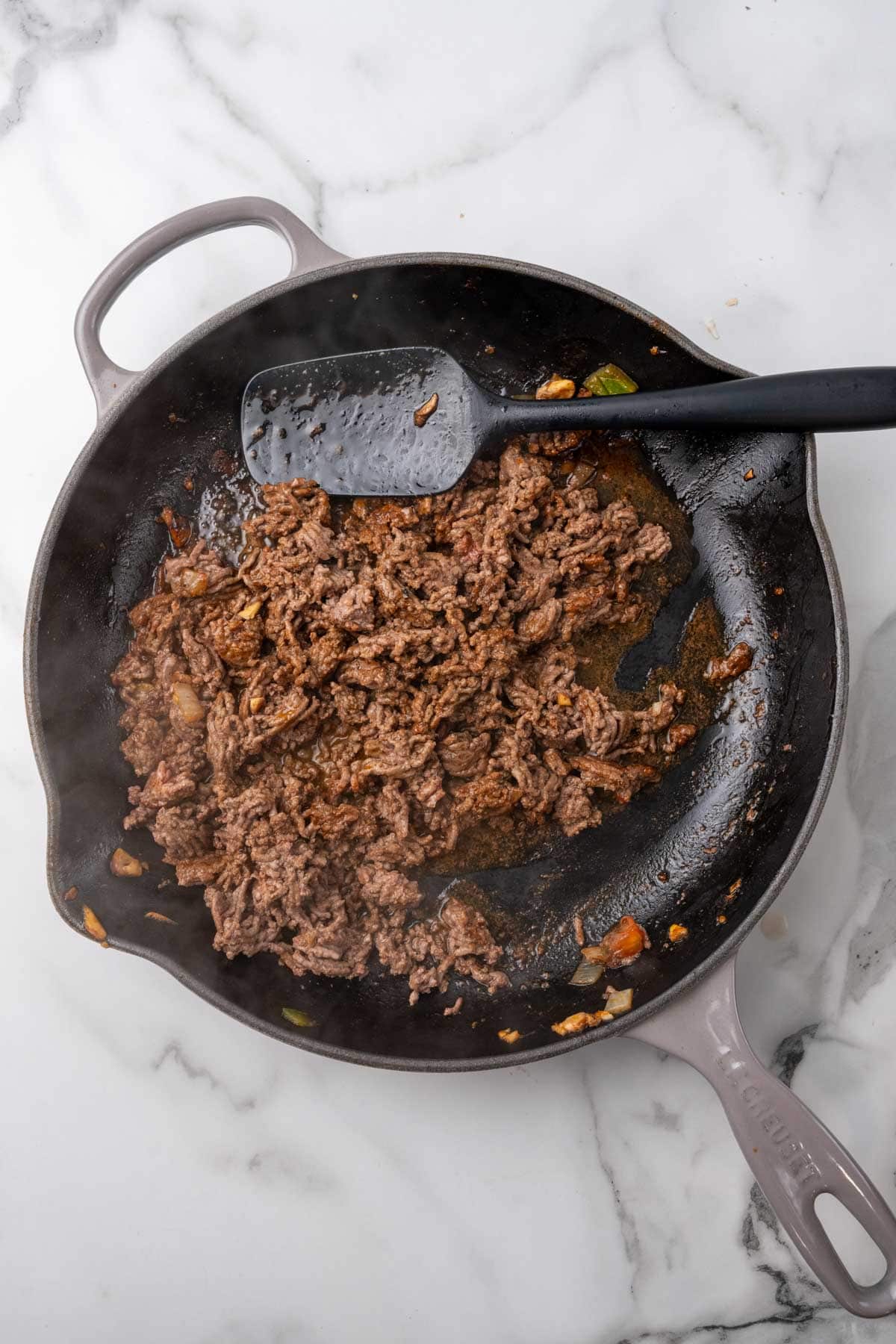 Beef and paprika cooking in a skillet