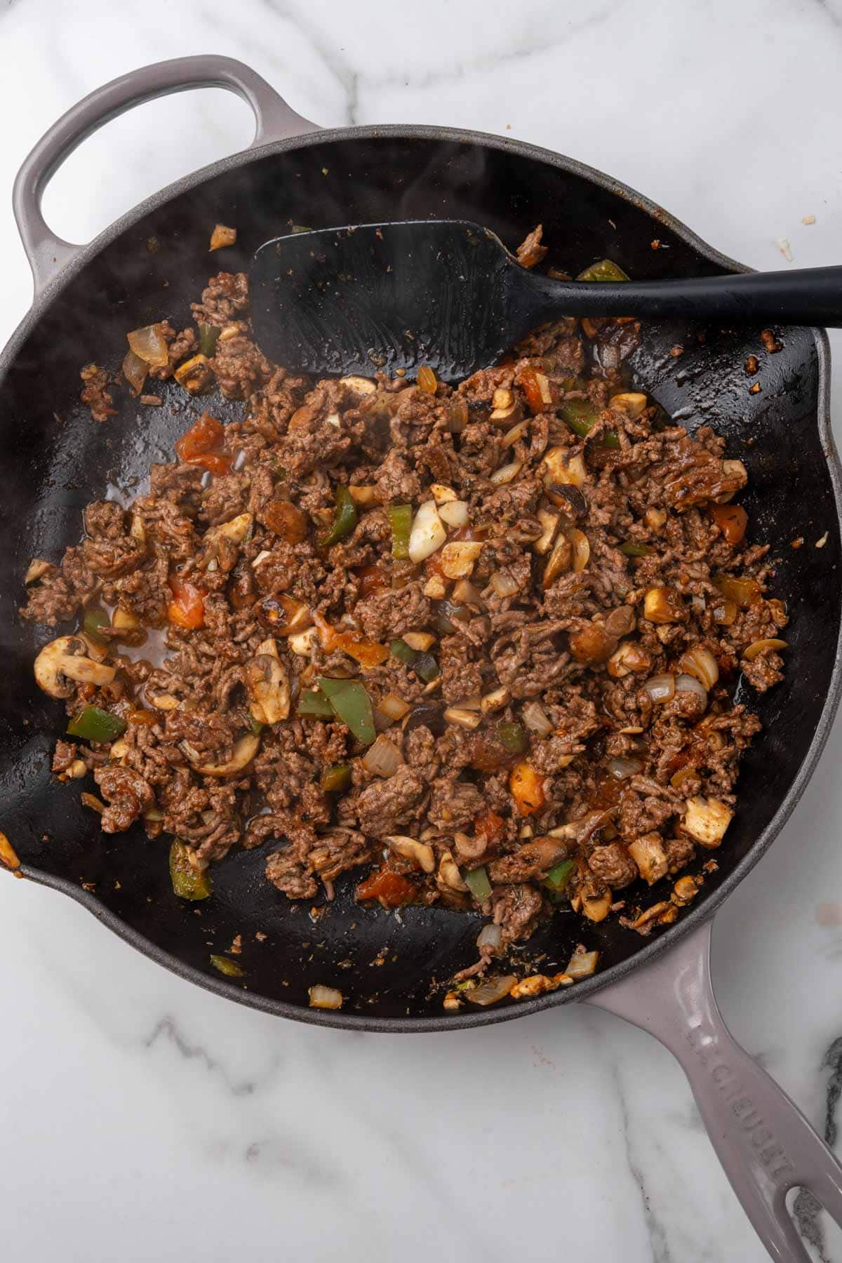 Vegetables and beef sautéing in a skillet