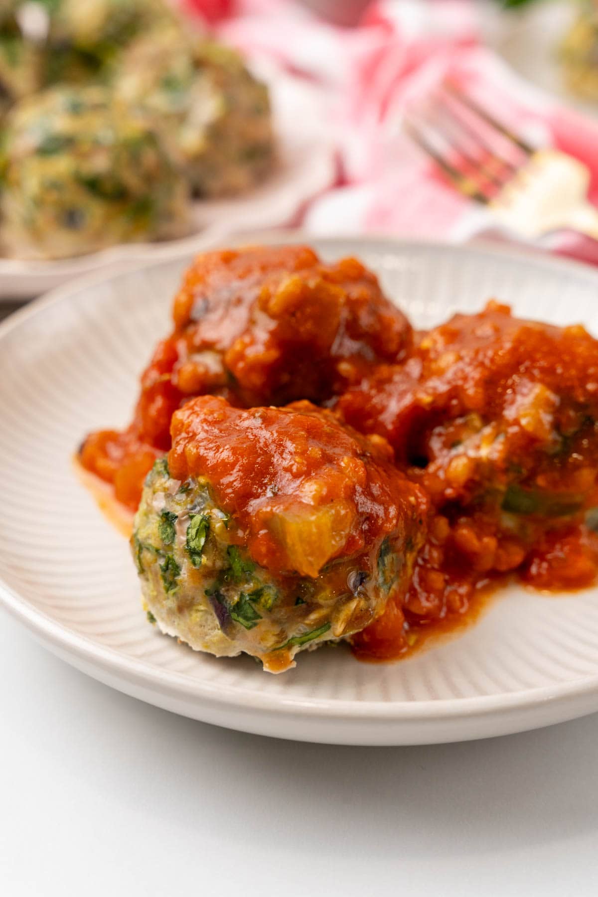 Plate of turkey meatballs covered in tomato sauce