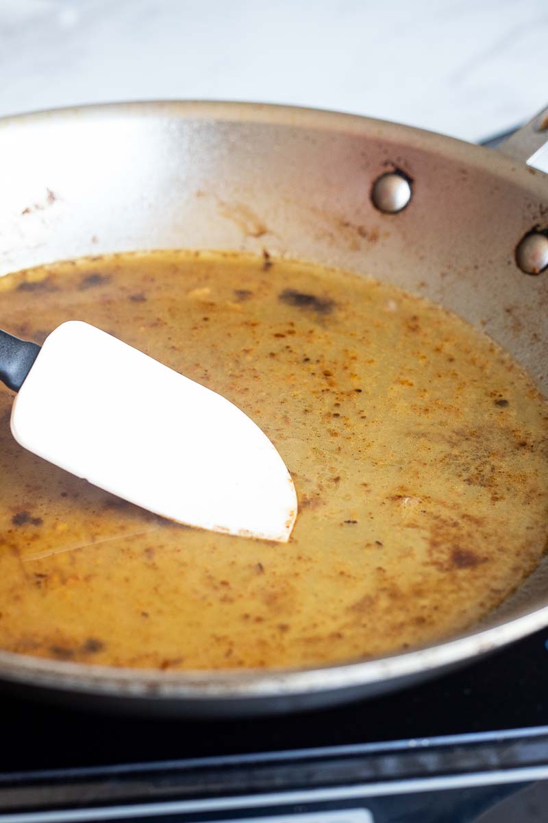 Reducing the sauce in a pan
