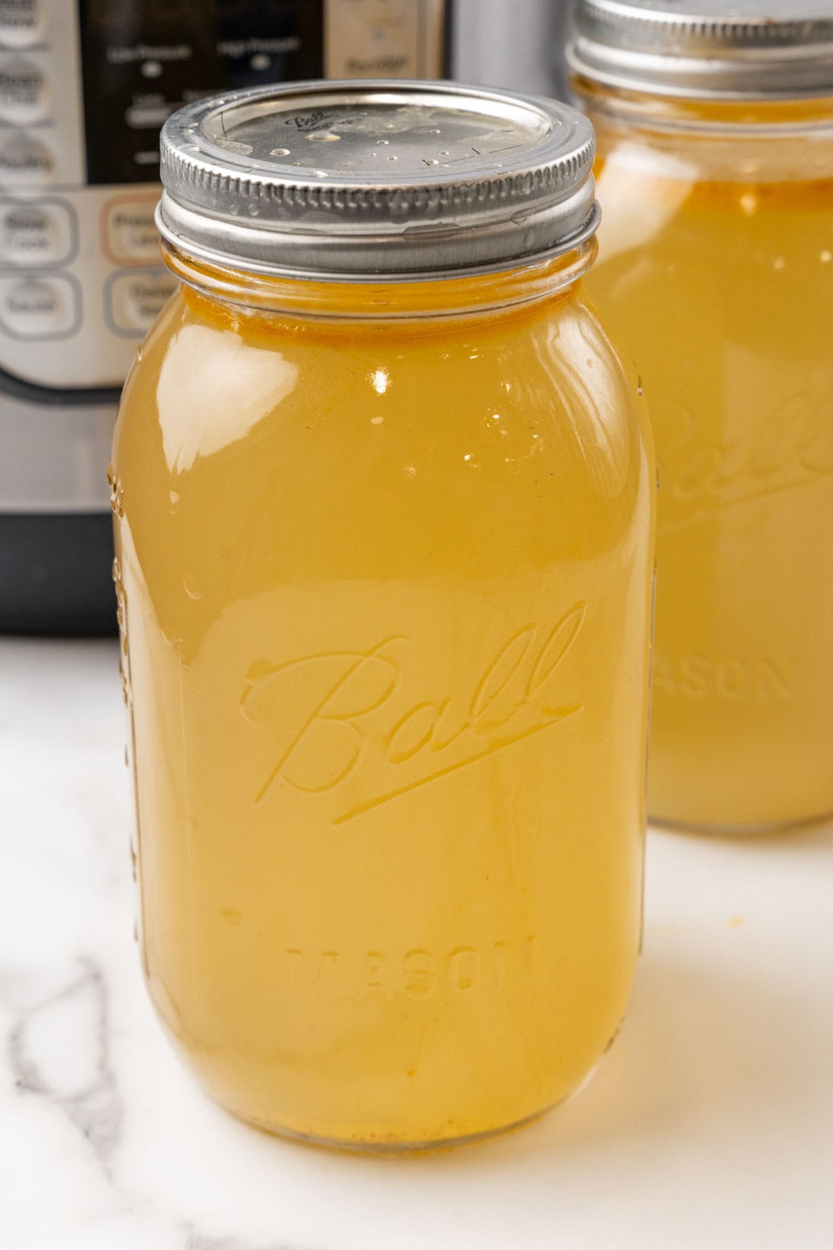 Sealed glass jar of chicken bone broth