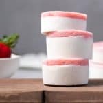 Stack of strawberry fat bombs on a wooden board