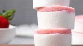 Stack of strawberry fat bombs on a wooden board