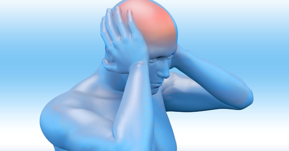 Image of a man holding his head with a headache