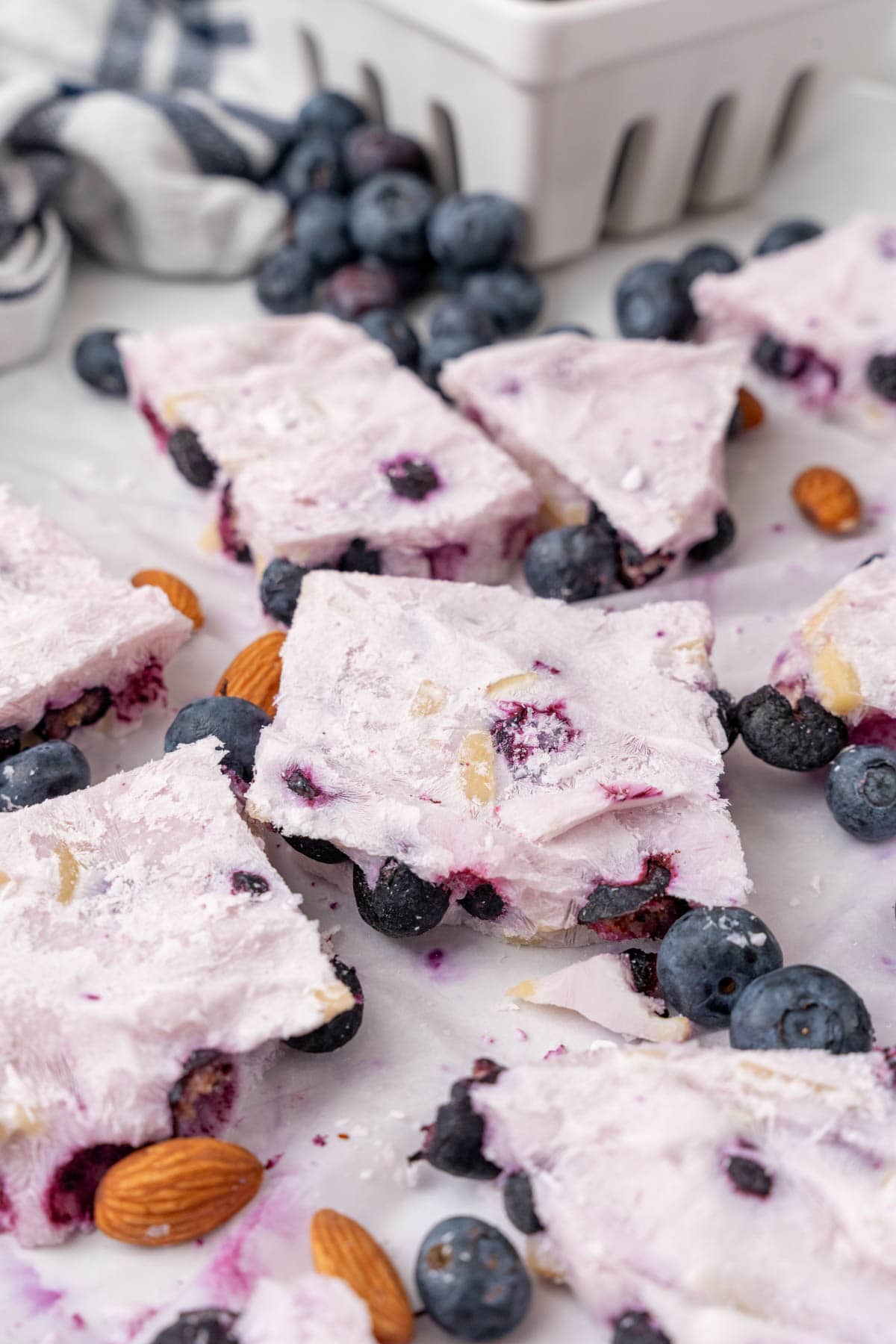 Pieces of frozen yogurt bark with blueberries and almonds