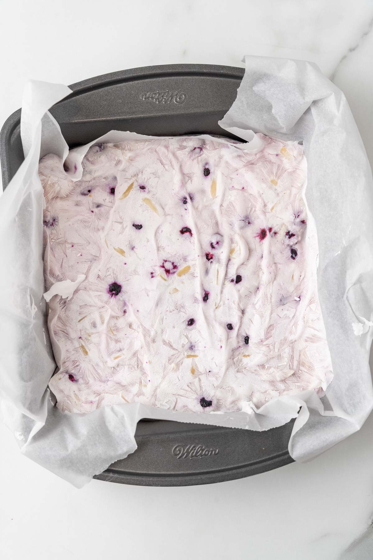 Frozen yogurt bark in a baking dish