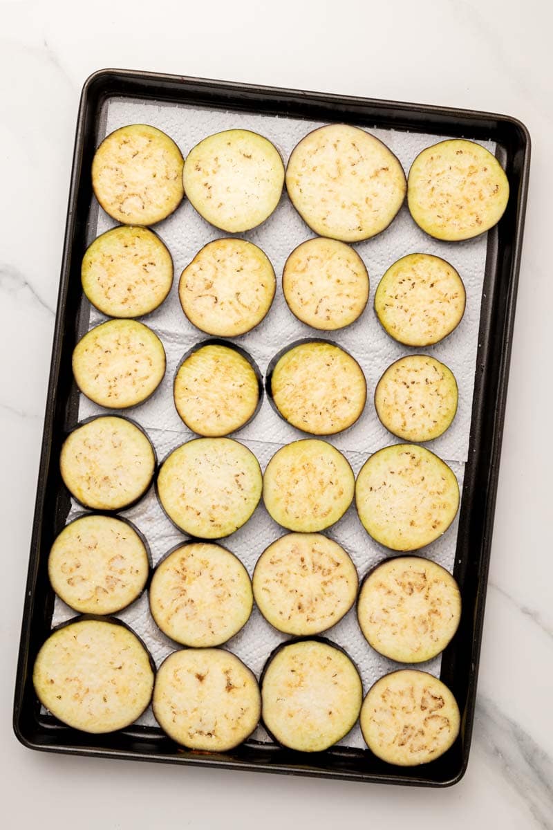 Eggplant rounds on a baking tray being dried