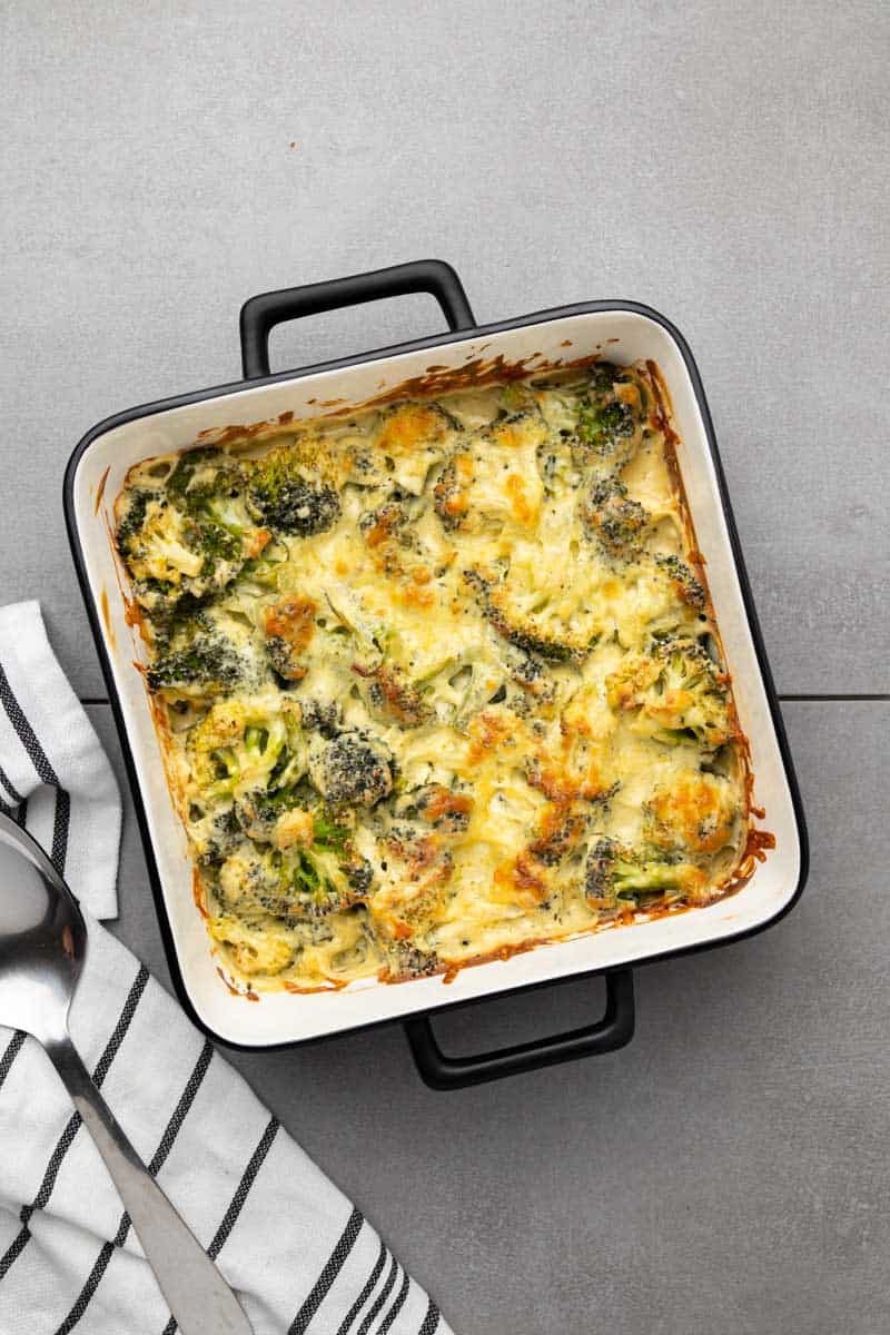 Keto broccoli casserole baked in a square baking dish, as seen from above