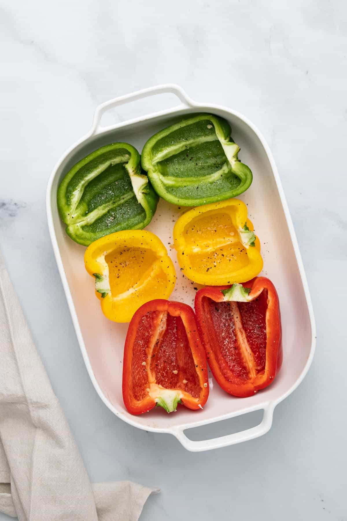 prepared and seasoned peppers in casserole dish