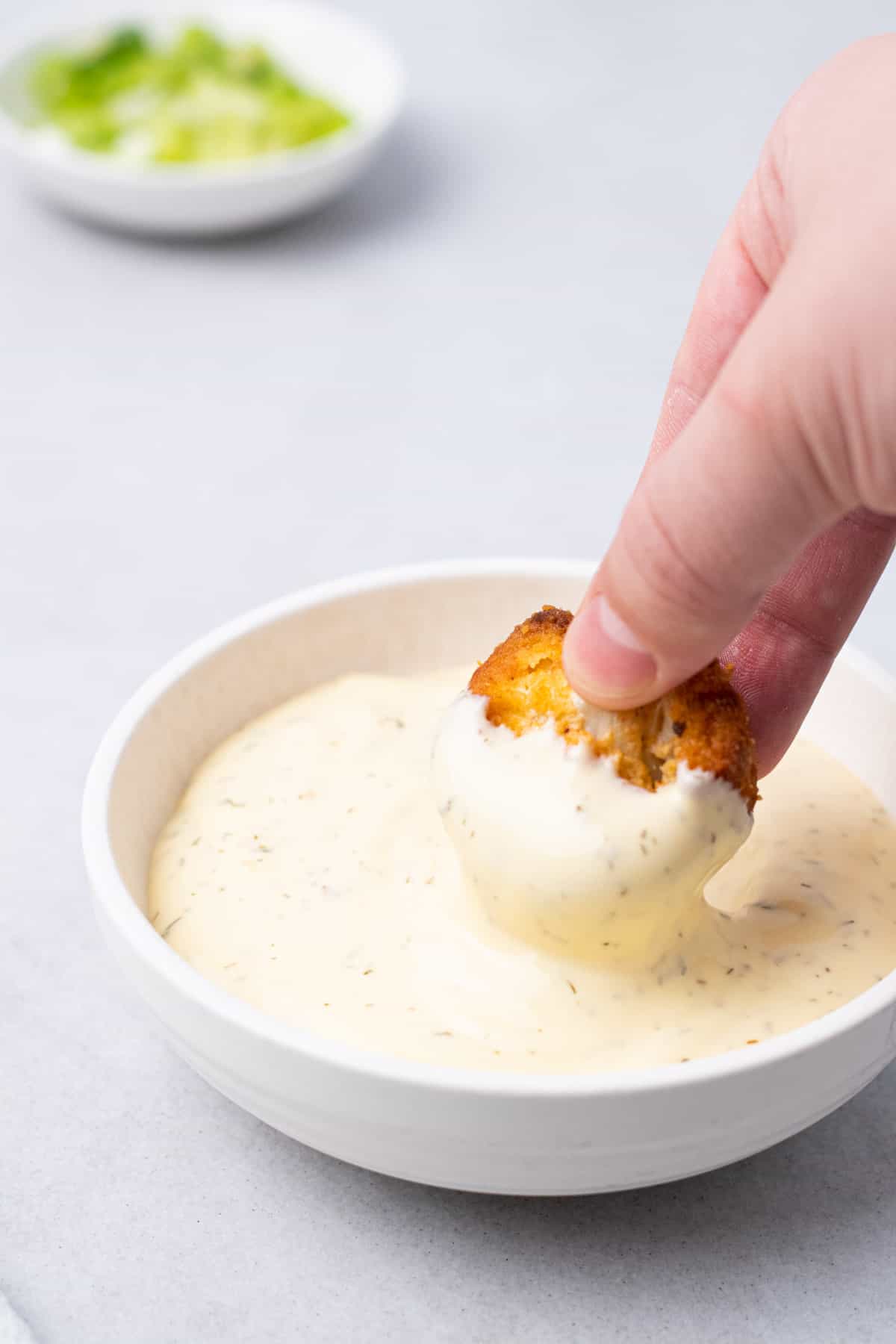 dipping a wing in ranch dressing 