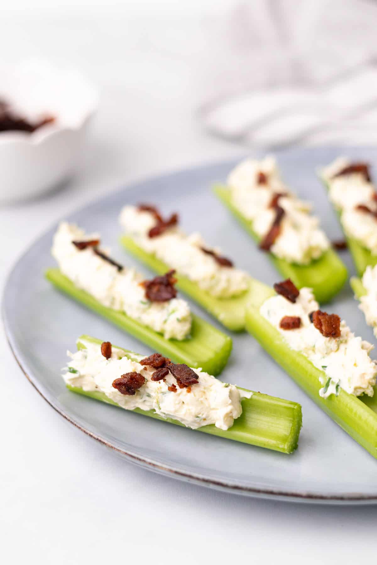 6 stuffed celery stalks on a plate