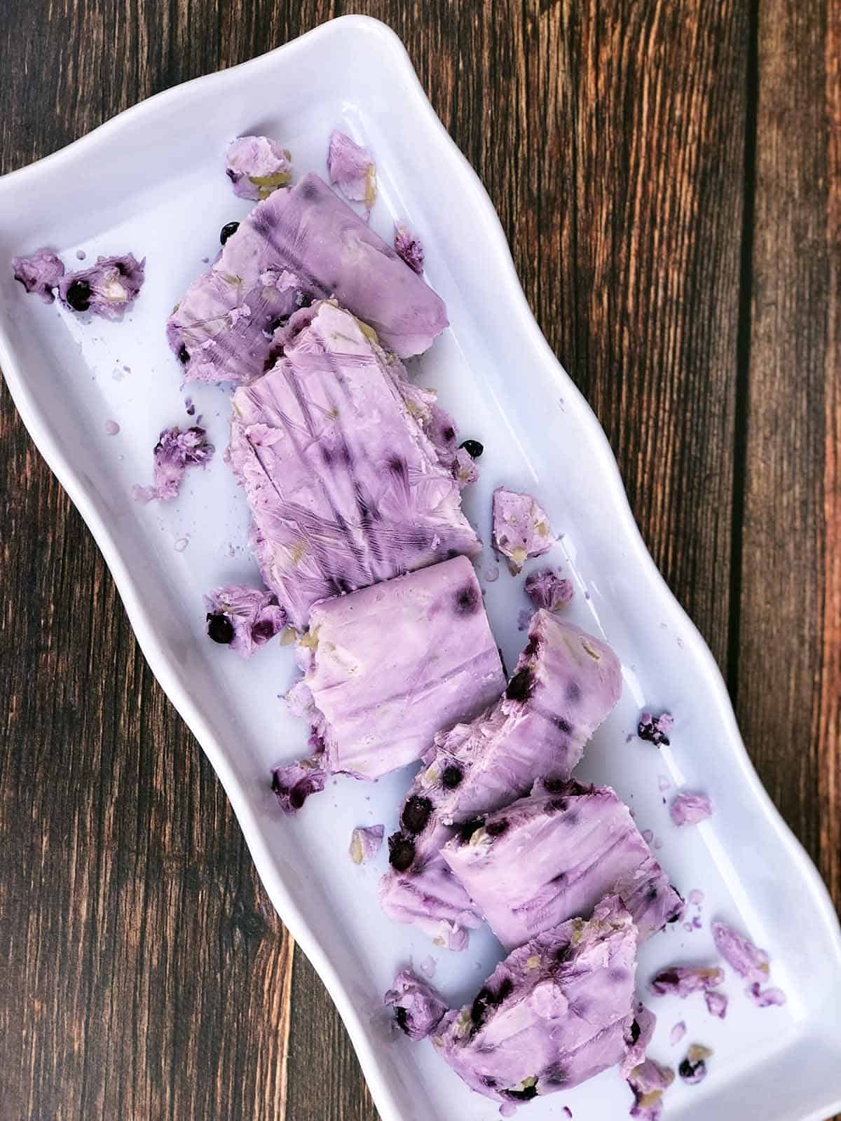 Frozen Yogurt Bark with Blueberries & Almonds on a white serving tray
