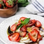 Mozzarella, strawberries, and mint drizzle of a white plate