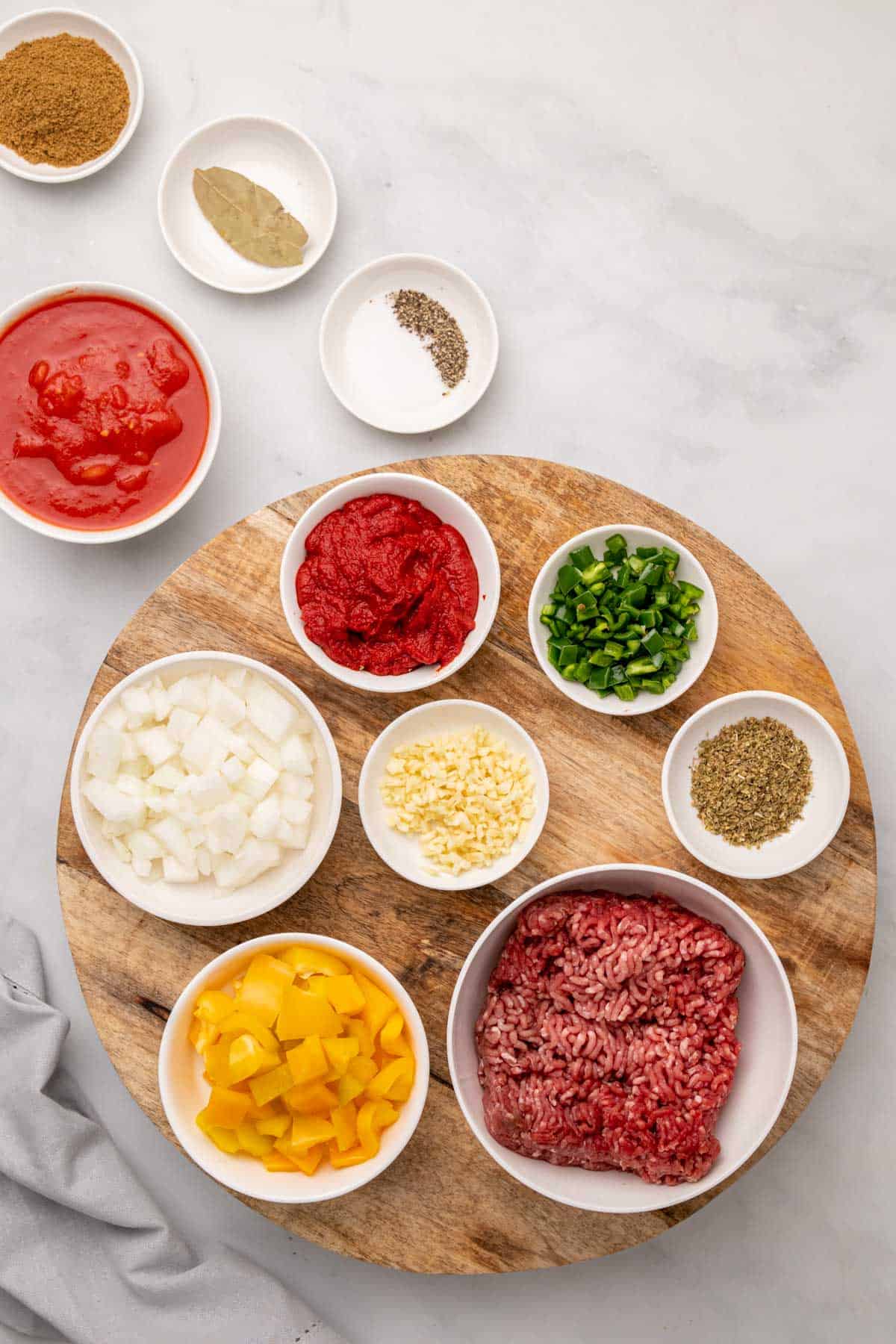 Ingredients for chili in separate ramekins, as seen from above
