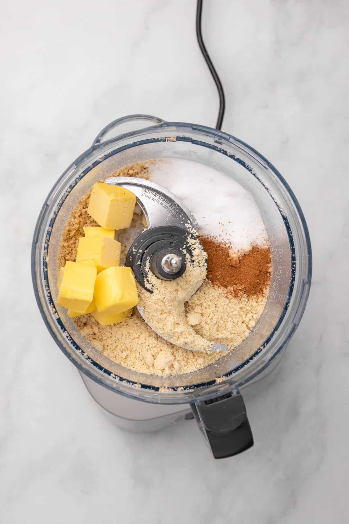 Topping ingredients in a food processor, as seen from above