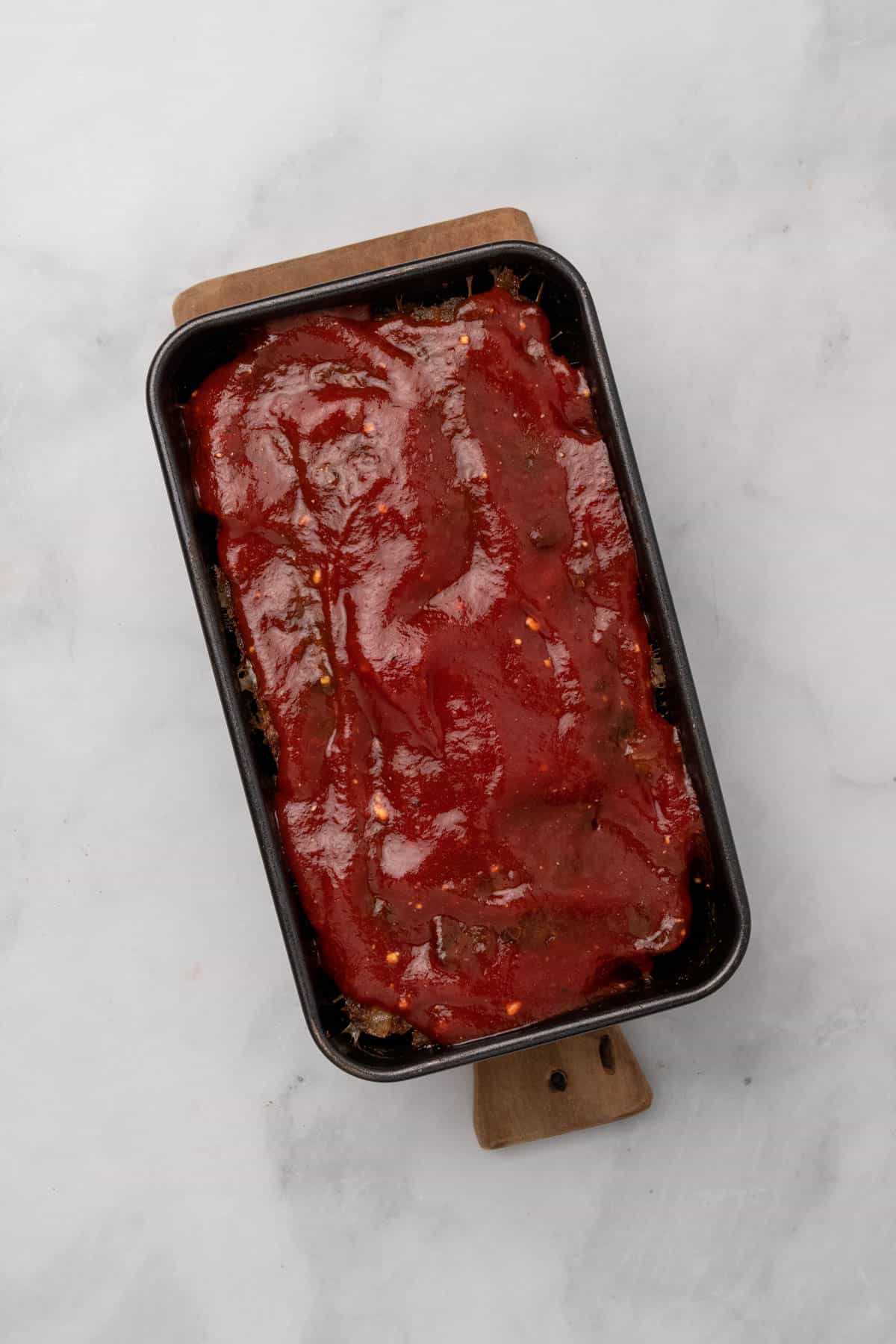 Tomato topping added to the meatloaf