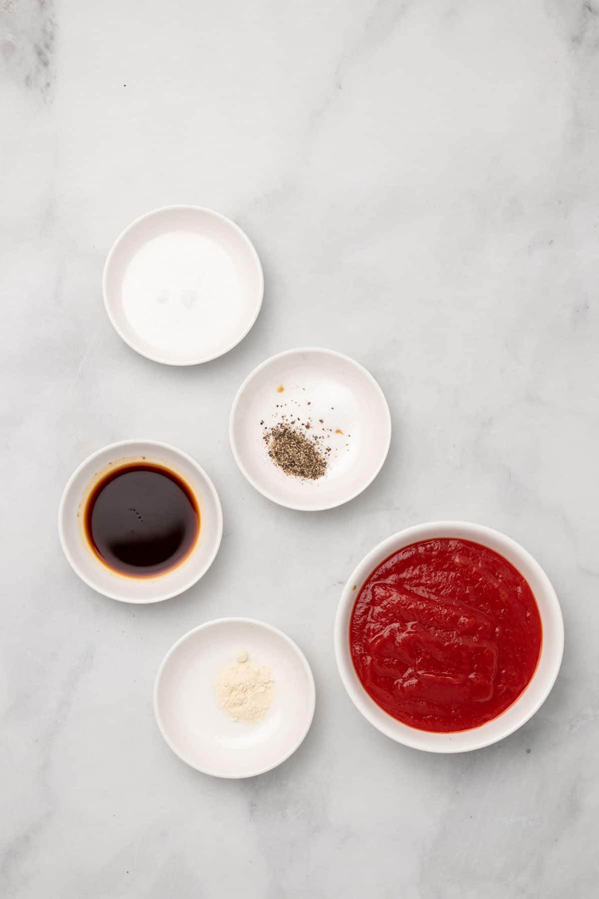 Ingredients for tomato glaze in separate ramekins