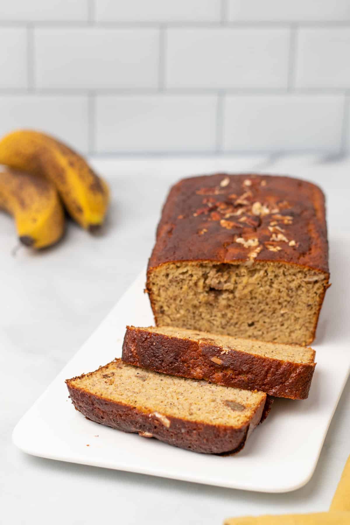 Loaf of banana bread with 2 slices cut