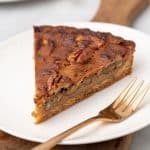 Slice of pecan pie on plate with fork