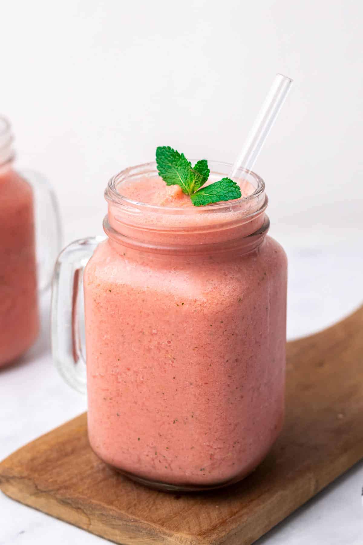 Low-Carb Watermelon Smoothie garnished with mint in a glass with a straw