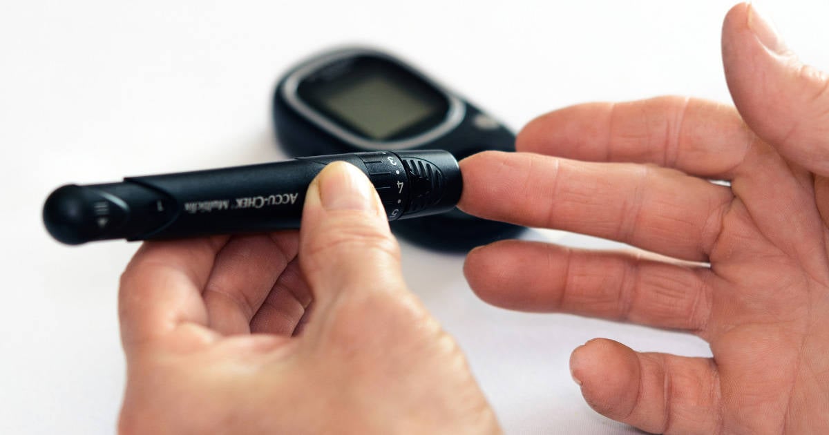 Hands of person measuring blood sugar