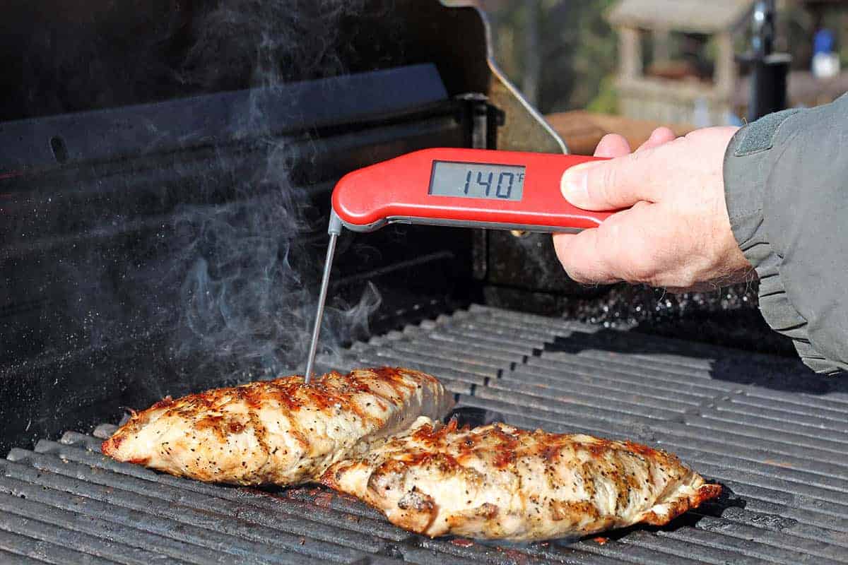 Turkey on the grill with a cooking thermometer