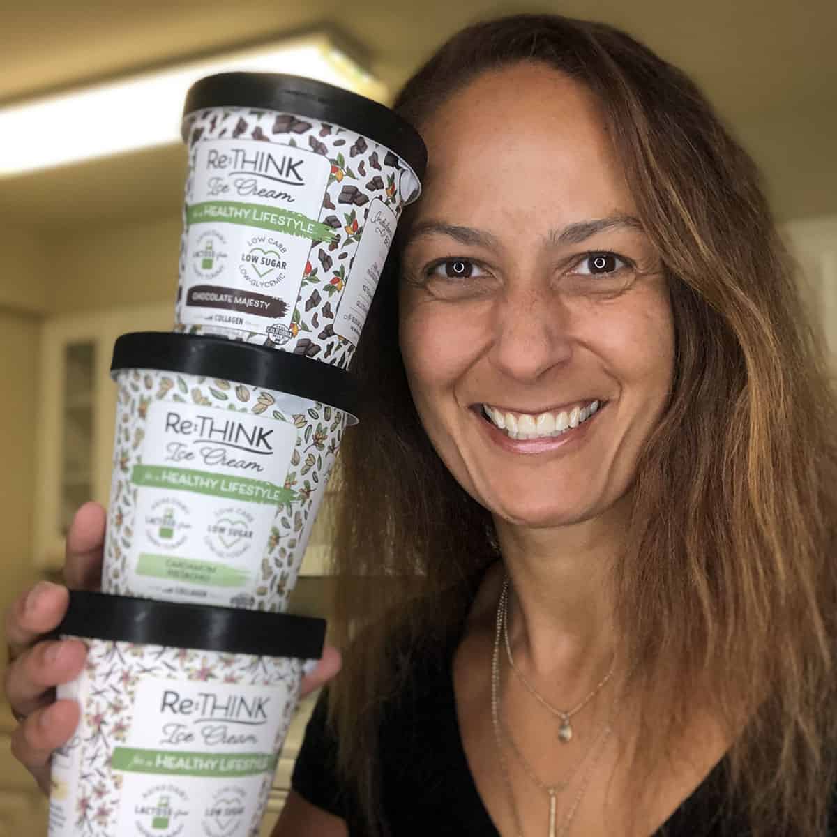 Christel holding three pints of Re:THINK low-carb ice cream