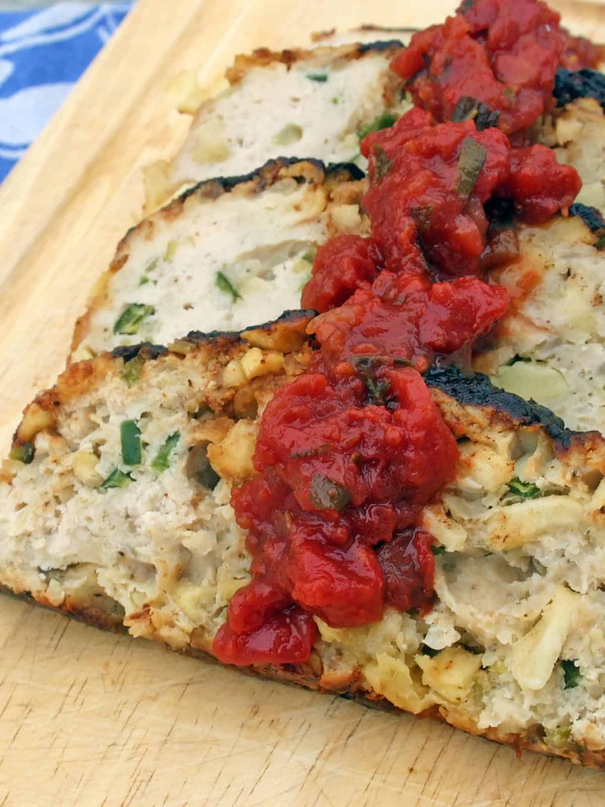 Chicken Apple Meatloaf cut into slices on a wooden cutting board